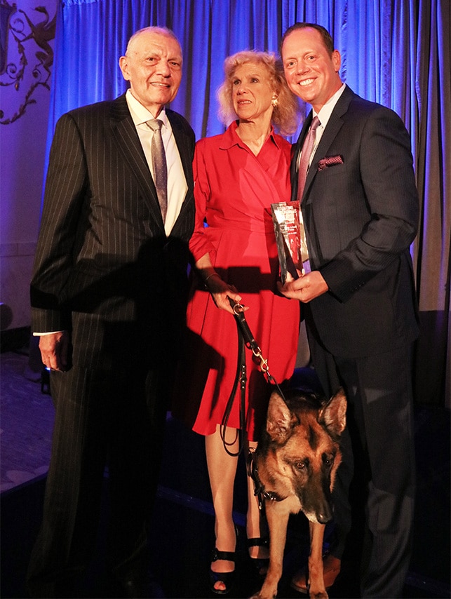 Karen P. and her guide dog at an award ceremony