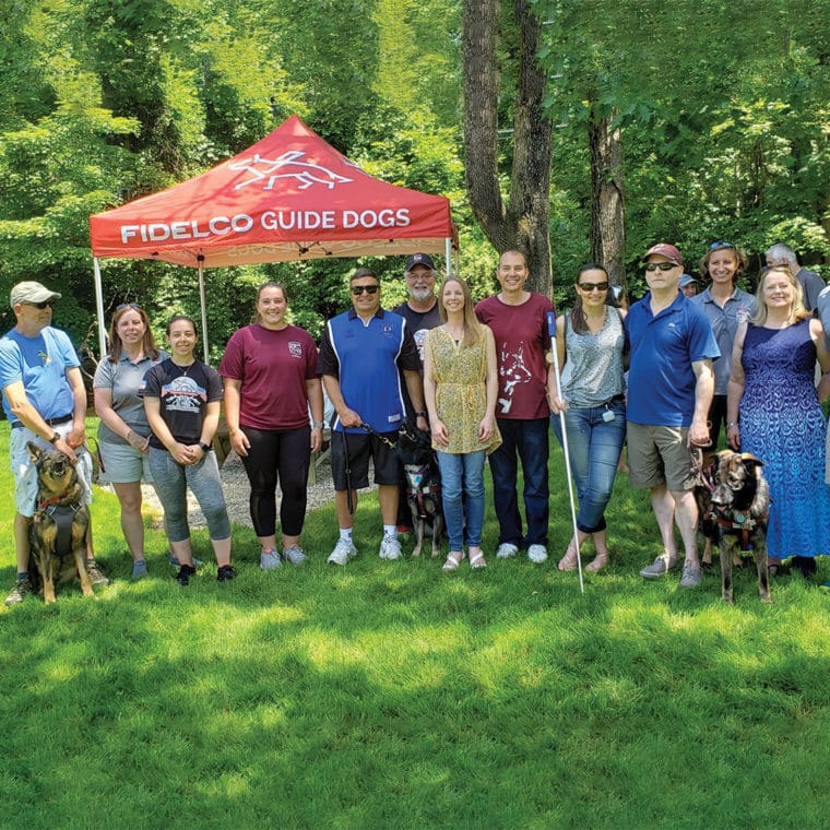 Photo of some staff members in front of a Fidelco tent