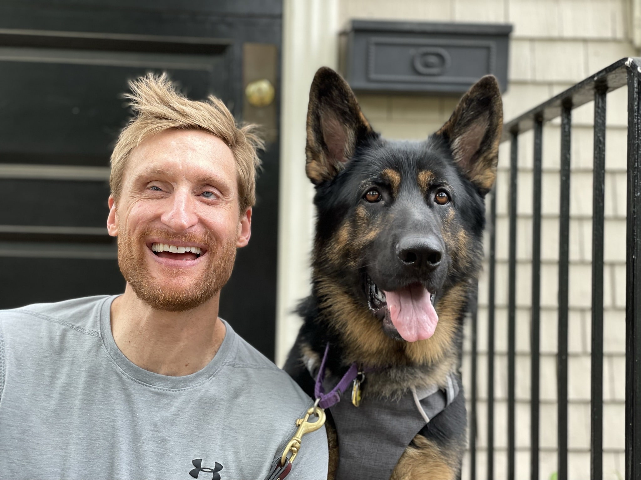 Lt. Brad S. and Fidelco guide dog, "Timber" smiling on their front step