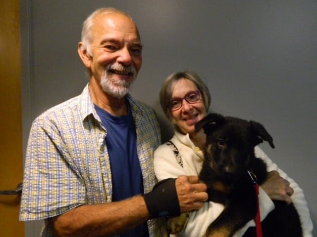 ed and adele smiling holding fidelco pup vader