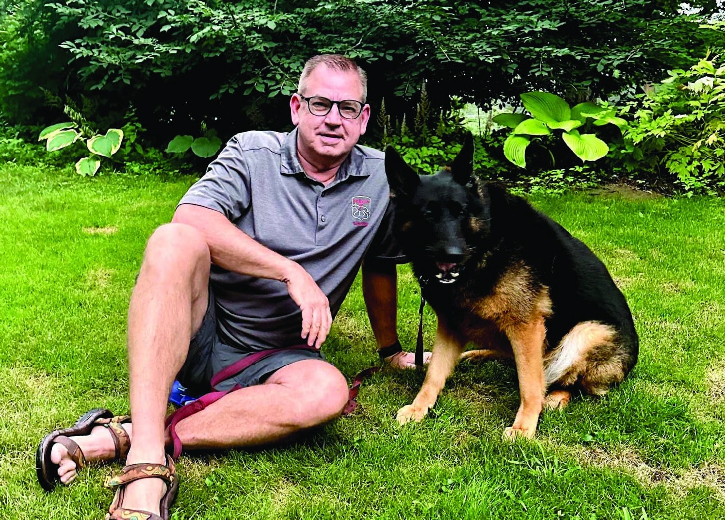 Chis Norwood sitting on grass with Leeta.